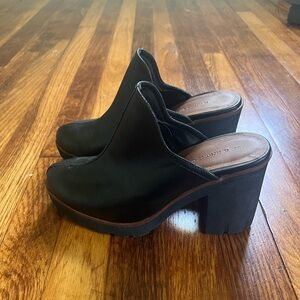 High heeled black leather clogs